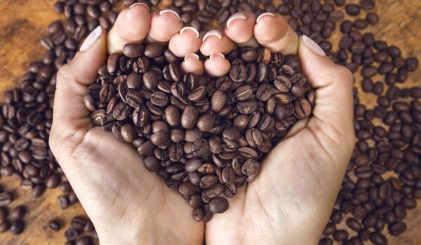 Heart shaped coffee beans hand held